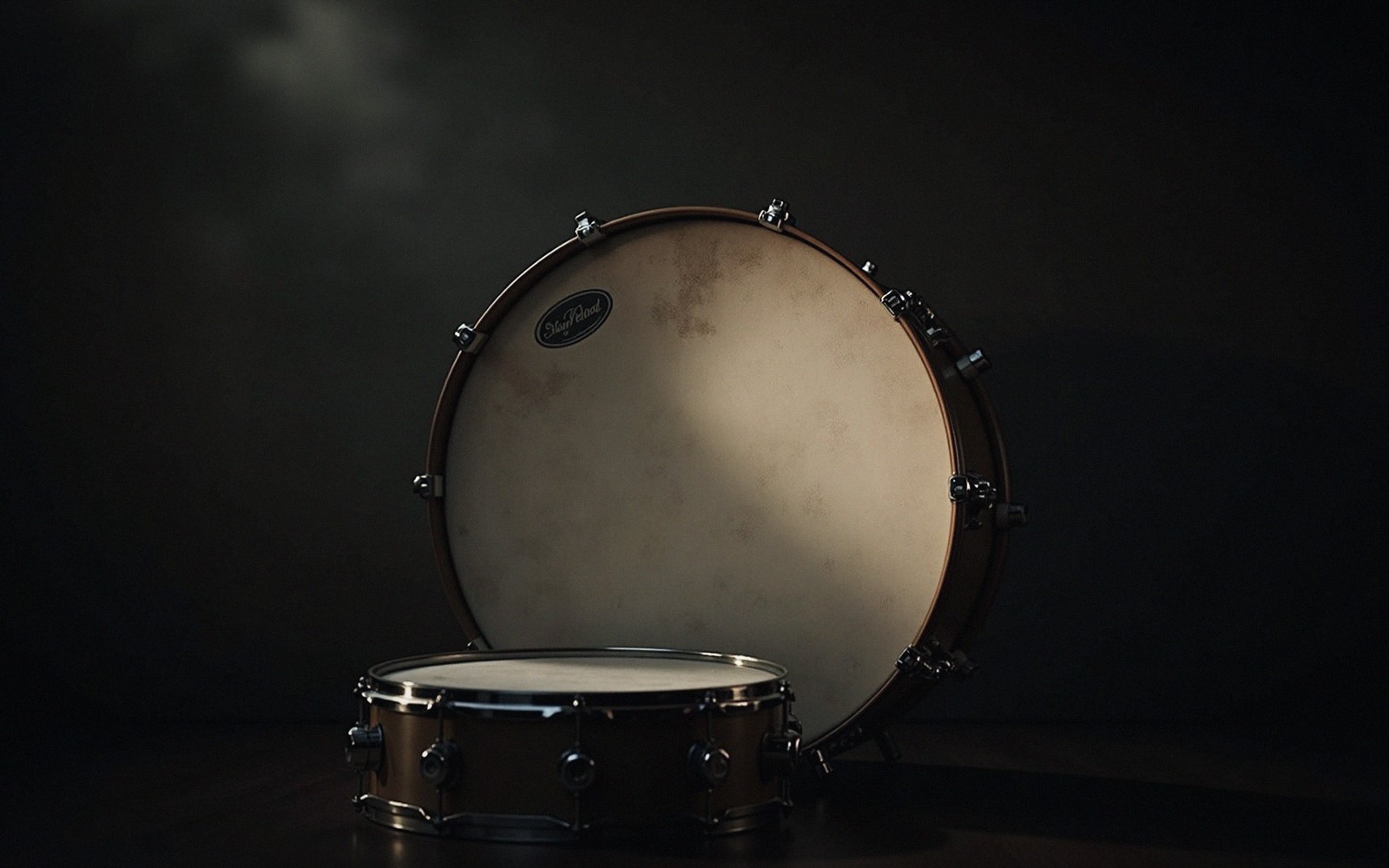 A bass drum head lit hard from the side