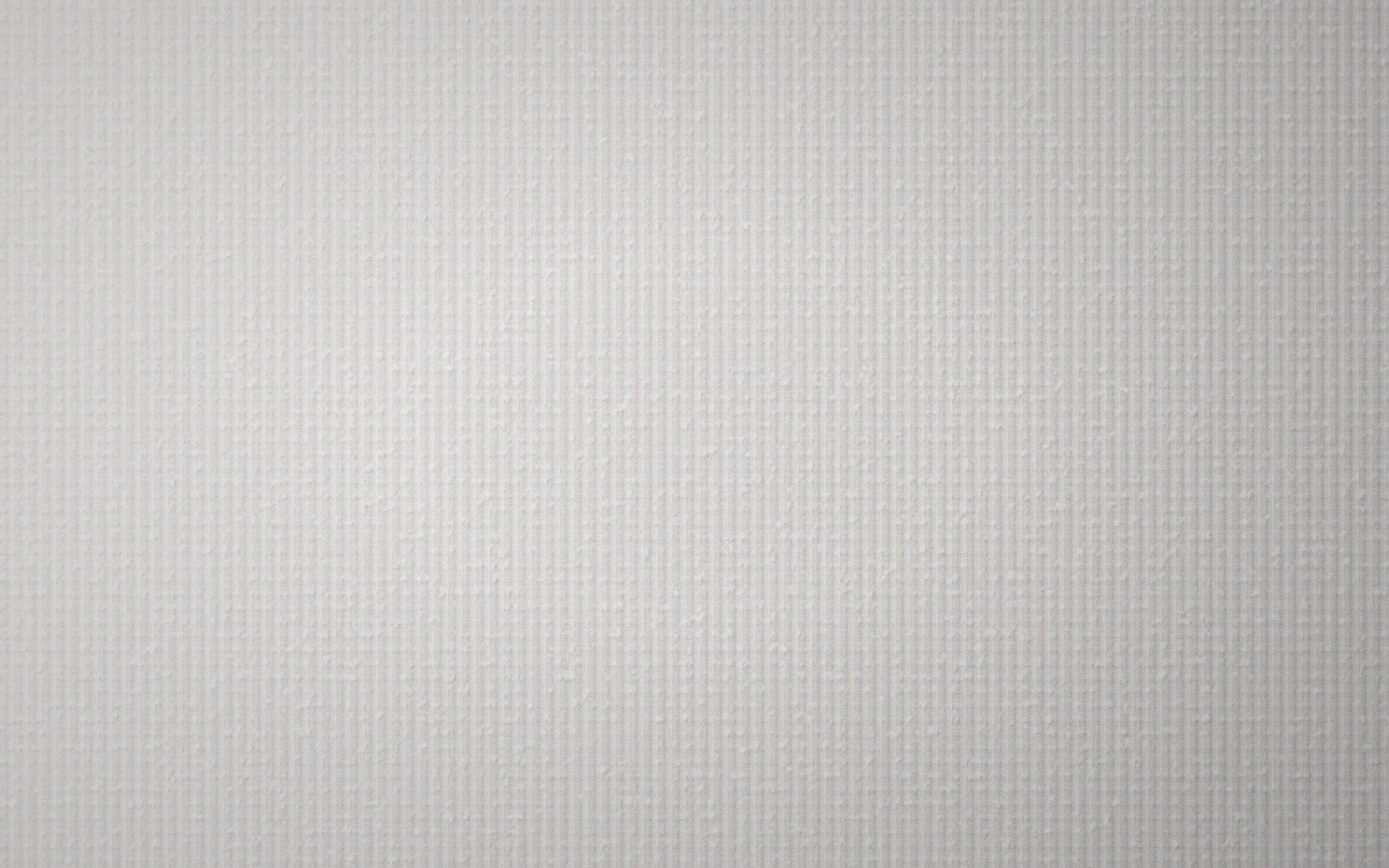Close-up of a subtly textured off-white paper surface with a fine grid pattern